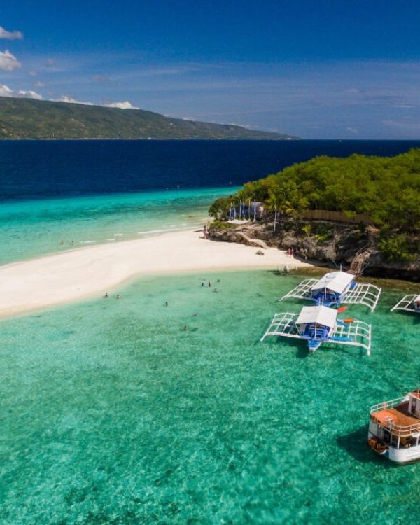 An aerial perspective of the Sumilon island beach landing near Oslob, Cebu, Philippines.